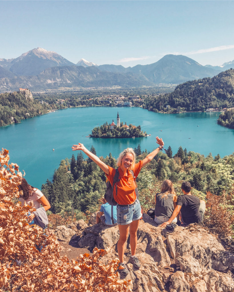 Female hiker and View of mountains and lake bled from viewpoint