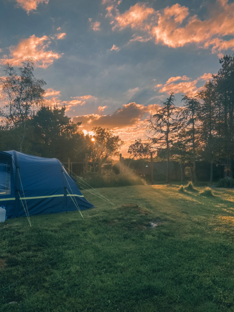 sunset and tent at wills field campsite pembrokeshire